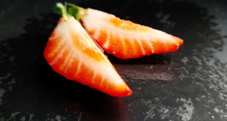  Strawberry slices. Delicious strawberries on a black background.