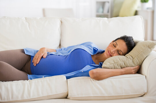 Pregnant woman napping on couch