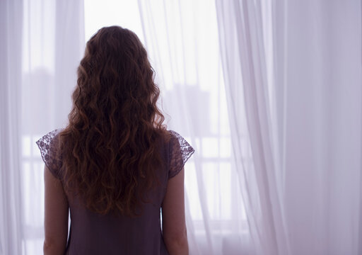 Woman looking out window