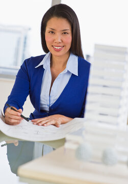 Female architect looking at blueprints