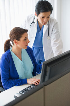 Doctor and nurse looking at computer