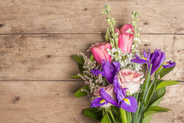 A beautiful bouquet of wedding flowers on old wooden boards