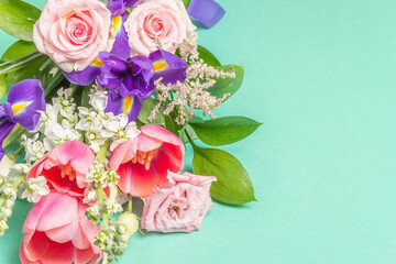 A beautiful bouquet of fresh flowers on a turquoise pastel background