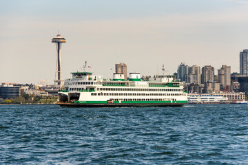 USA, Washington State, Puget Sound. Washington State ferry in Elliott Bay. Space Needle in renovation. Waterfront and skyline