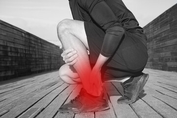 Running and workout injuries. Athlete suffering from ankle pain or achilles injury. Ankle twist sprain accident