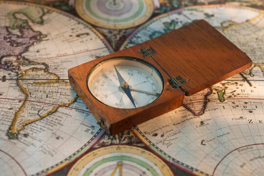 Antique compass on map