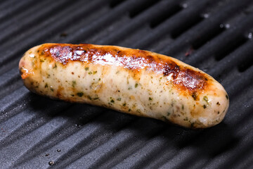 Delicious german sausages on the barbecue electro grill. Tasty sausages sizzling on a portable electric grilling on a summer picnic, close up view. 4k resolution video.