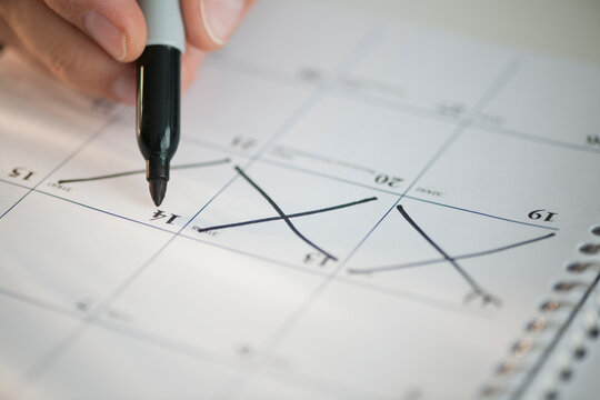 USA, New Jersey, Jersey City, Man writing on calendar