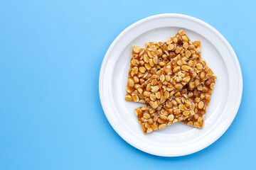 Honey bars with peanuts on blue background
