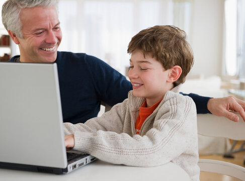Father and son using laptop