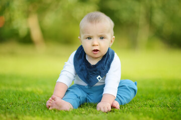 Cute five months old baby boy learning how to sit up without support. Baby during floortime.