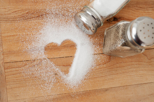 Heart shaped spilt salt on table