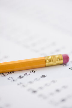 Pencil with eraser on school test sheet