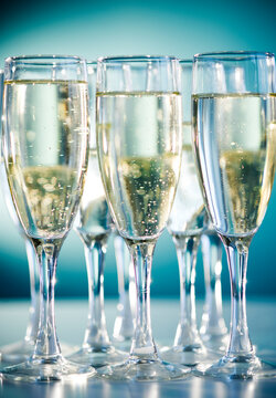 Close up of champagne flutes on blue background