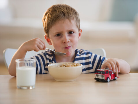 Young boy eating cereal