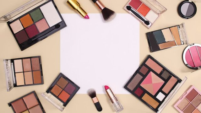 Make up cosmetics products move around paper card note on nude background. Beauty flay lay stop motion