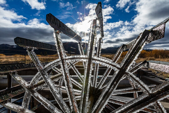 USA, Idaho, Stanley, Frosted water wheel on ranch in morning sun