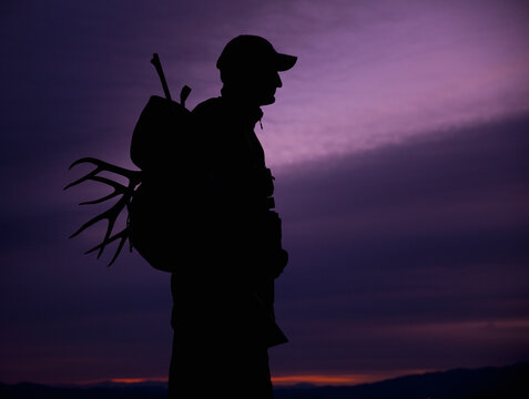 Hunter with deer antler in his backpack