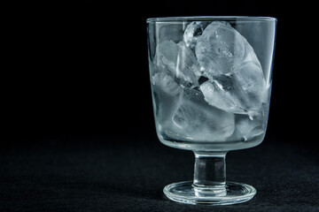 Glass full of ice on a black background