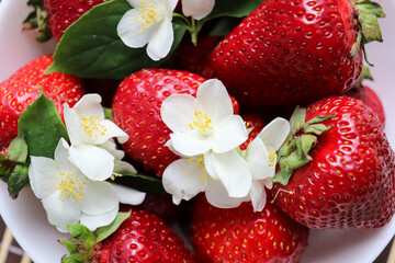 ripe fresh strawberries on a white dish 