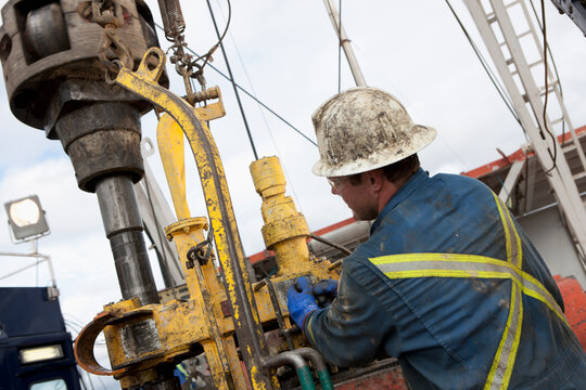 Oil worker drilling for oil on rig