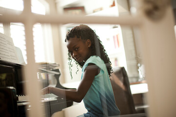 Young girl playing piano