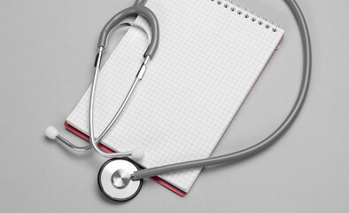 Stethoscope, notepad on a grey background. Healthcare and medical concept with copy space.Banner