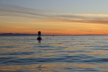 silhouette of a buoy at sunset