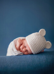 little newborn baby sleeping on a blue blanket