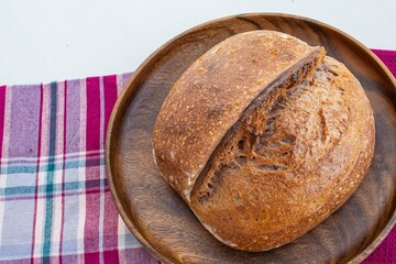 Homemade rye bread on the wooden plate. Crispy crust.