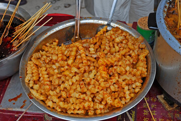 China, Nanjing cooked potatoes offer in the big  Fuzimiao market. - 421657928