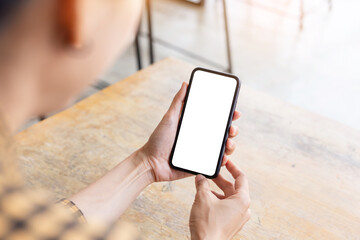 cell phone blank white screen mockup.woman hand holding texting using mobile on desk at office.background empty space for advertise.work people contact marketing business,technology