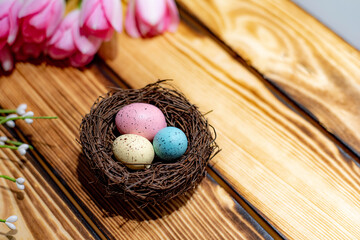 Spring Pink Tulips and Easter Egg Nest on Wood