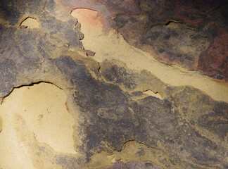 Full frame close-up view of a the surface of a weathered big sandstone rock
