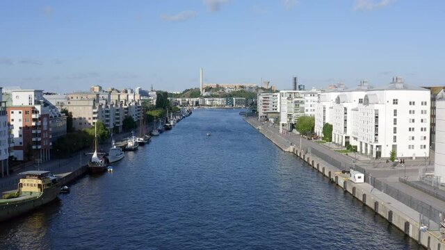 Stockholm, Sweden, Scandinavia. Aerial Drone summer view above a peaceful canal and bay at Hammarby Sj&ouml;stad with modern architecture, marina, old vintage boats.