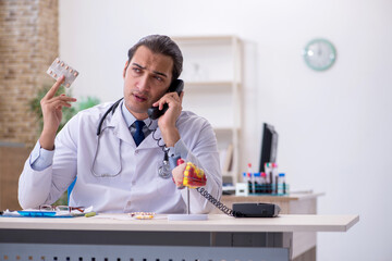 Young male doctor cardiologist working in the clinic