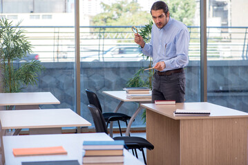 Young male teacher in the classroom