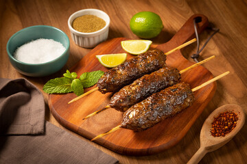 Beef kafta on the wooden board. Kafta, Traditional Arabic cuisine.