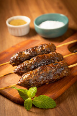 Beef kafta on the wooden board. Kafta, Traditional Arabic cuisine.