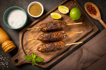Beef kafta on the wooden board. Kafta, Traditional Arabic cuisine.