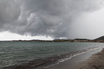 View of storm clouds on the beach in Golfo Marinella Sardinia, Italy