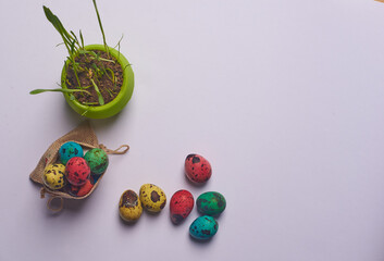 a pot of grass and a bag of Easter eggs