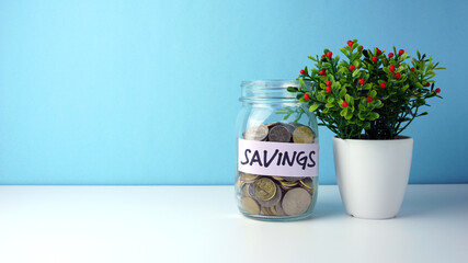 Conceptual of money savings. Photo of coins inside the glass jar.