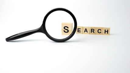 "SEARCH" word with magnifying glass, business concept. Isolated on white background