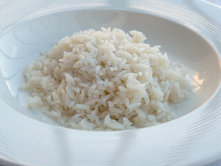Grained white rice in a white bowl. Arroz blanco. 
