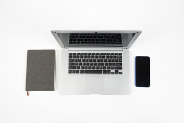 White office desk table with laptop computer and office supplies. Top view with copy space, flat lay.