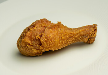 Fried chicken thigh on a bench plate. Pica pollo