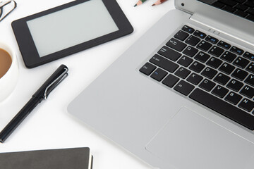 White office desk table with laptop computer and office supplies. Top view with copy space, flat lay.