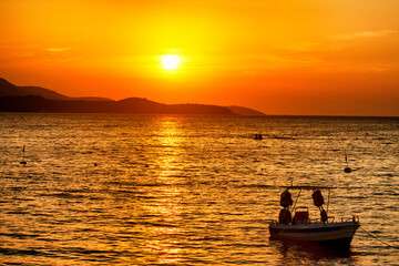 Fototapeta na wymiar Silhouette Boat In Sea Against Sky During Sunset
