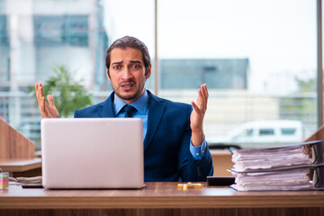 Young male employee working in the office